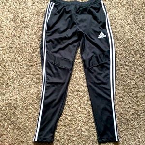 Black Adidas pants with white stripes